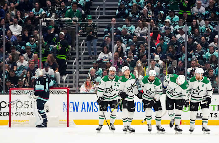 The Stars celebrate a goal by Jamie Benn against Seattle Kraken goaltender Philipp Grubauer.